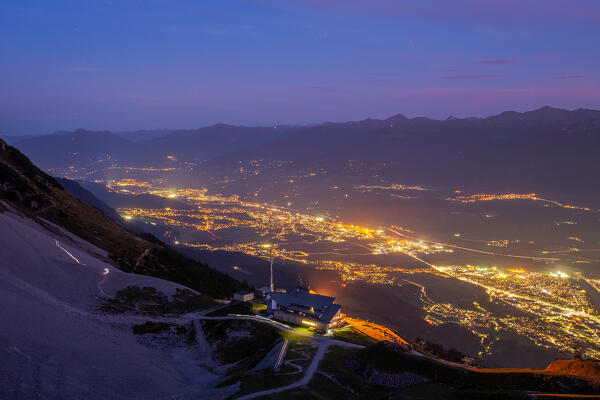 The view of the Seegrube Cable way station with the city lights of Innsbruck and of the other towns of the Inn Valley at blue hour, Nordkette, Innsbruck, Tyrol, Austria, Europe
