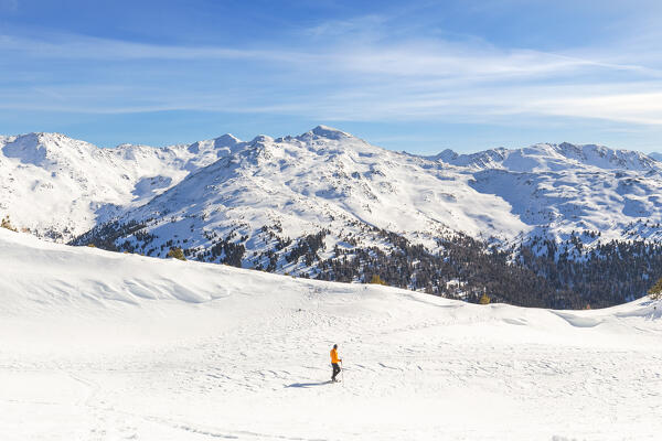 A hiker admiring the Tux Alps during a hike with snowshoes to Patscherkofel mountain, Patsch, Innsbruck Land, Tyrol, Austria, Europe