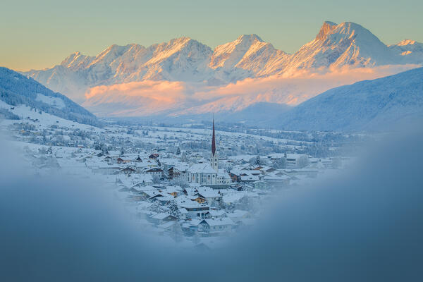 The snow-covered charming village of Axams with the Mieming mountain range in the background at sunset, Axams, Westliches Mittelgebirge, Innsbruck Land, Tyrol, Austria, Europe