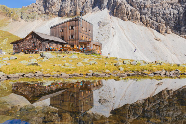 Rifugio Calciati al Tribulaun mirroring itself on a little pond in the nearby of Lake Sandesee - Lago di Sanes, Ladurns, Bolzano district, South Tyrol, Italy, Europe