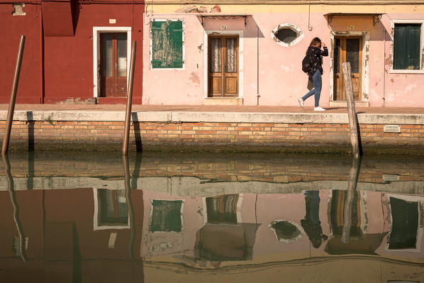 a woman walking down Riva dei Santi, Burano, Venice, Veneto, Italy, Europe