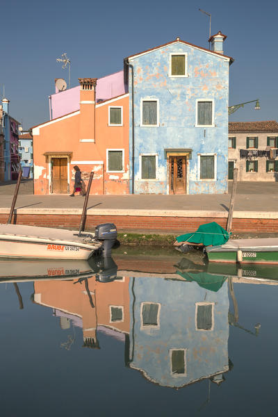 A woman walking down Fondamenta della Pescheria, Burano, Venice, Veneto, Italy, Europe