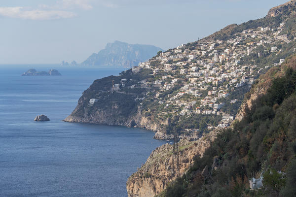 The white buildings of Praiano with Capri in the background,Conca dei Marini, Salerno province, Campania, Italy, Europe