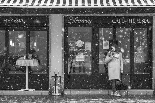A girl on the phone in the main street of the city, Innsbruck, Tyrol, Austria, Europe