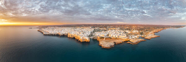 Aerail and panoramic view of Polignano a Mare during a summer sunrise (province of Bari, Apulia, Italy)