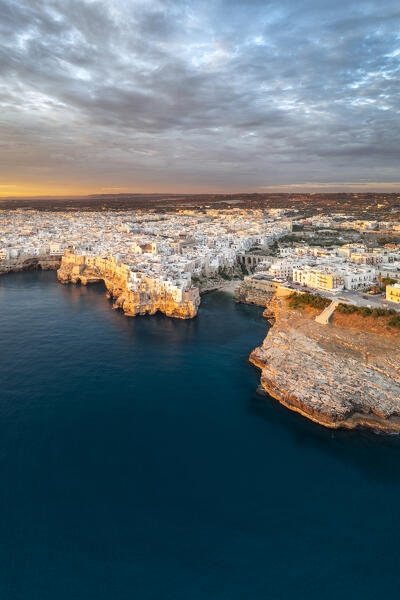 Aerail view of Polignano a Mare during a summer sunrise (province of Bari, Apulia, Italy)