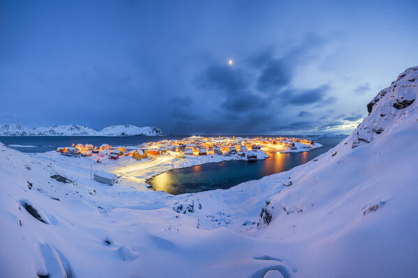 Coastal village of Sorvaer covered with snow during twilight in the cold arctic winter (Soroya Island, Hasvik, Troms og Finnmark, Norway)