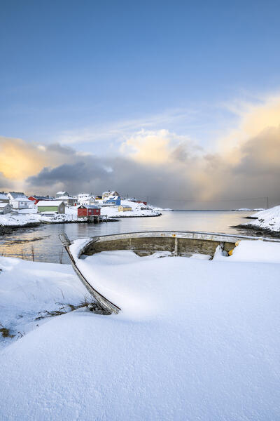 Coastal village of Sorvaer covered with snow during sunrise in the cold arctic winter (Soroya Island, Hasvik, Troms og Finnmark, Norway)