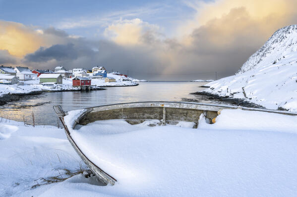 Coastal village of Sorvaer covered with snow during sunrise in the cold arctic winter (Soroya Island, Hasvik, Troms og Finnmark, Norway)
