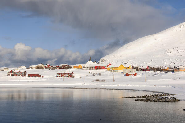 Coastal village of Hasvik covered with snow during the cold arctic winter (Soroya Island, Troms og Finnmark, Norway)