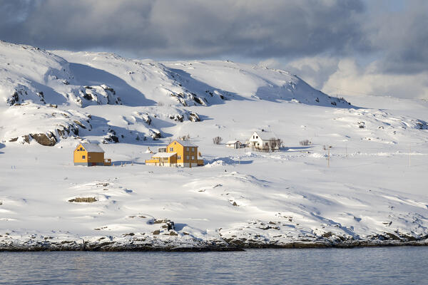 Hasvik Village: houses covered with snow during the cold arctic winter (Soroya Island, Troms og Finnmark, Norway)