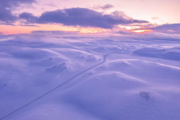 Aerial view of the Tanafjordveien road during a winter sunset (Tana, Troms og Finnmark, Norway)