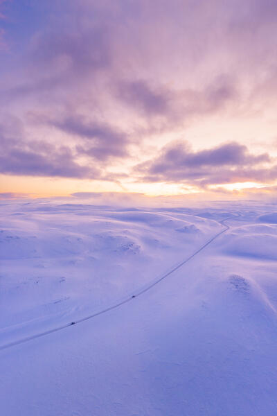 Aerial view of the Tanafjordveien road during a winter sunset (Tana, Troms og Finnmark, Norway)