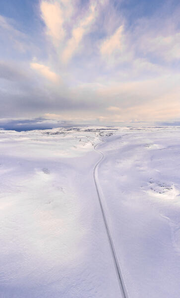 Aerial view of the Tanafjordveien road during a winter sunset (Tana, Troms og Finnmark, Norway)