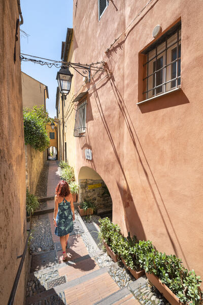 A woman is walking in a alley in the small village of Cervo (province of Imperia, Liguria, Italy) (MR)
