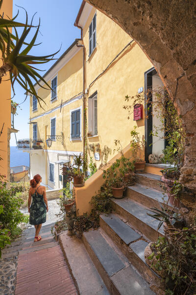 A woman is walking in a alley in the small village of Cervo (province of Imperia, Liguria, Italy) (MR)