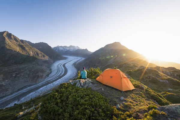 A woman admires the Aletsch Glacier at sunrise (Riederalp, Bernese Alps, Canton of Valais, Switzerland, Europe) (MR)