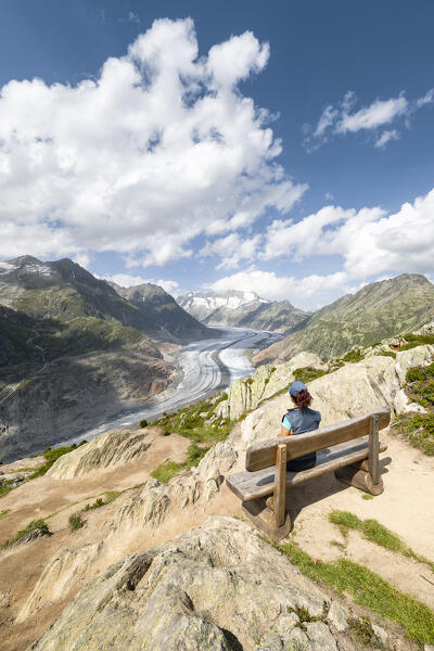 A woman admires the Aletsch Glacier from the Moosfluh viewpoint (Riederalp, Bernese Alps, Canton of Valais, Switzerland, Europe) (MR)
