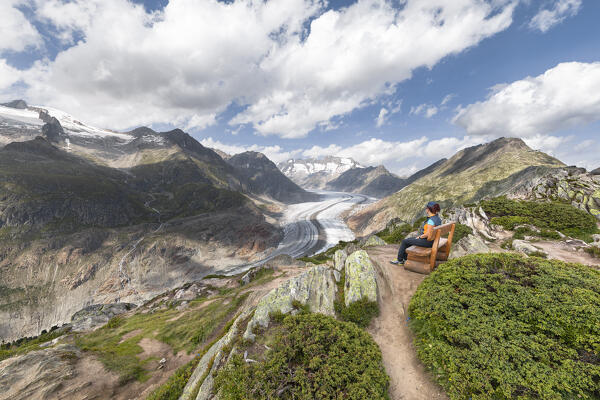 A woman admires the Aletsch Glacier from the Moosfluh viewpoint (Riederalp, Bernese Alps, Canton of Valais, Switzerland, Europe) (MR)