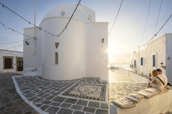 Relaxing in front of the church of Panagia Korfiatissa in the village of Plaka (Milos Island, Cyclades Islands, Greece, Europe)