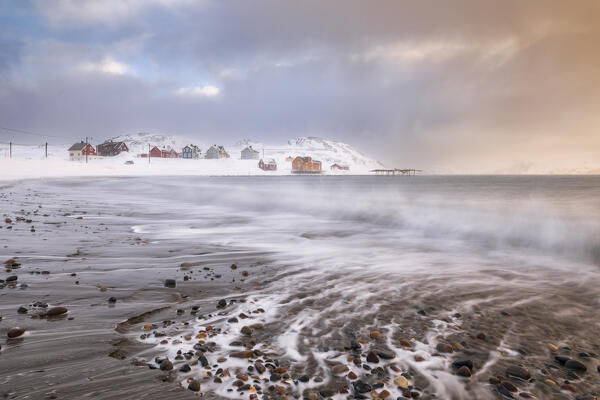 The village of Veines covered in snow during a windy winter sunrise (Kongsfjord, Varanger Peninsula, Troms og Finnmark, Norway)