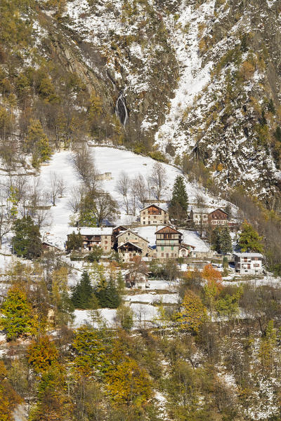 An hamlet over Riva Valdobbia (Alagna), a small village at the foot of Monte Rosa, during a cold autumn: the first snow coveres the lodges and the colored trees. (Alagna Valsesia, Valsesia, Vercelli province, Piedmont, Italy, Europe)