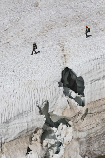Mountaineers walk on Lys glacier near the Gnifetti refuge in Monte Rosa Massif (Gressoney, Lys Valley; Aosta province, Aosta Valley, Italy, Europe)