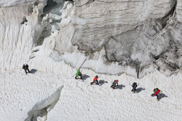 Mountaineers walk on Lys glacier near the Gnifetti refuge in Monte Rosa Massif (Gressoney, Lys Valley; Aosta province, Aosta Valley, Italy, Europe)
