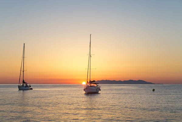 Sailing boats at sunrise, on background Capraia Island (Macinaggio, Rogliano, Bastia, Haute-Corse department, Corsica, France, Europe)