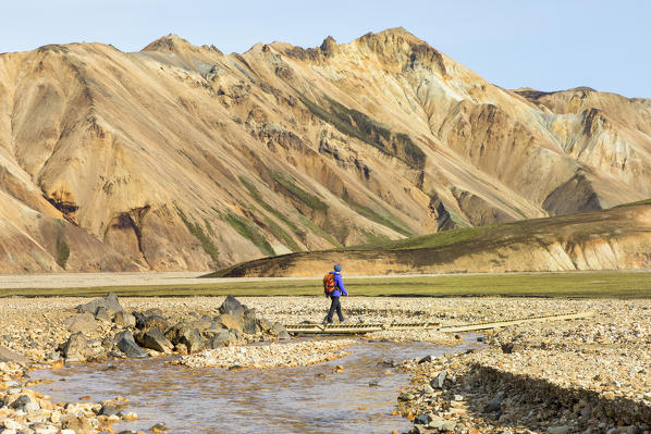 A trekker is walking to the Blahnukur mountain in Landmannalaugar (Fjallabak Nature Reserve, Highlands, Southern Region, Iceland, Europe) (MR)