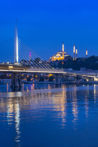 Nightscape of Halic Bridge with Suleymaniye Camii Mosque on the background. Golden horn, Istanbul, Turkey
