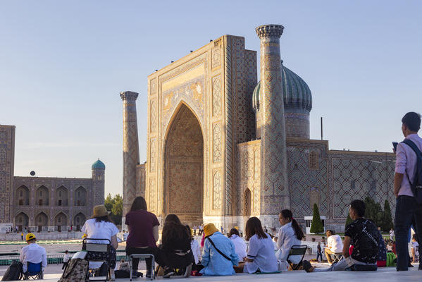 Peoples at Registan looking to Scher Dor Madrasah in Samarkand. Sammarcanda, Uzbekistan, Central Asia.