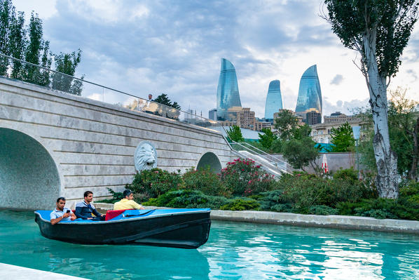 Mini-Venice boat with Flame Towers in the background in the Baki Bulvari area. Baku, Azerbaijan, Central Asia.