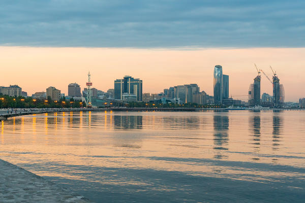 Skyline reflected in the Caspian sea at sunset. Baku, Azerbaijan, Central Asia.