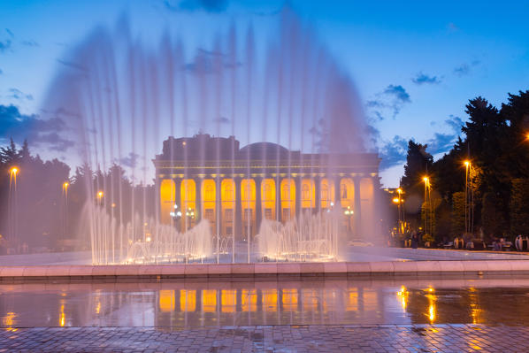 A building with a fountain in foreground alonge Baki Bulvari  at twilight. Baku, Azerbaijan, Central Asia.