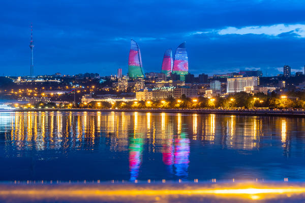 Flame towers cityscape at twilight from Caspian seafront. Baku, Azerbaijan, Central Asia.
