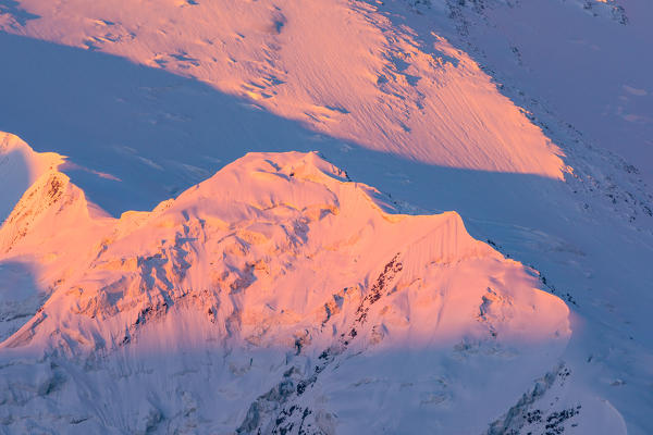 Mountains sunset over a peak of PiK Lenin group. Peak Lenin base camp, Pamir, Kyrgyzstan, Central Asia. 