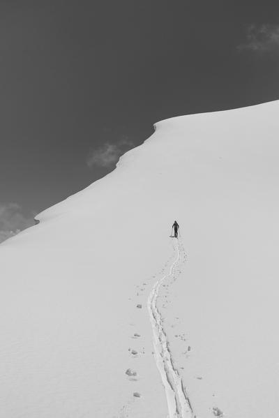 Alpinist during ski touring climb of Yuhina peak, a 5000 meters peak in the Peak Lenin group. Peak Lenin camp one, Pamir, Kyrgyzstan, Central Asia. 