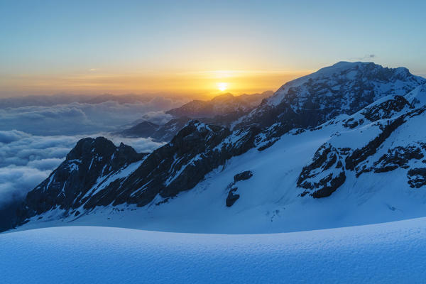 Sunrisescape from Punta degli Spiriti, Geister spitze, with Ortles, Ortler, and suninbacklight during winter season. Stelvio pass, Trafoi, Bolzano, Bozen, district, Alps, Trentino Alto Adige, Italy, Europe. 