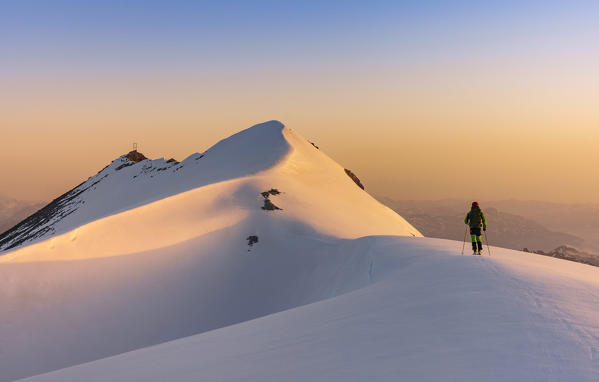The snow capped ridge and summit of Punta degli Spiriti, Geister spitze with the sunrise light . Stelvio pass, Stilfser joch, Bormio, SOndrio district, Alps, Lombardy, Italy, Europe.