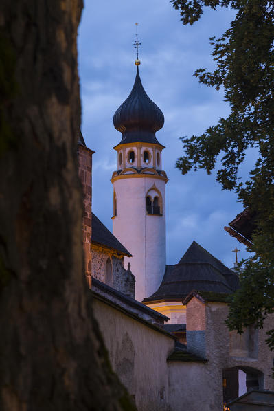 The medioeval Collegiata dei Santi Candido and Corbiniano church in the alpine village of San Candido during twilight. San Candido, Pusteria valley, Bolzano district, Dolomites, Trentino Alto Adige, Italy, Europe.