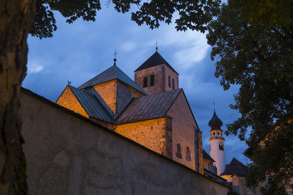 The medioeval Collegiata dei Santi Candido and Corbiniano church in the mountain village of San Candido at dusk. San Candido, Pusteria valley, Bolzano district, Dolomites, Trentino Alto Adige, Italy, Europe.