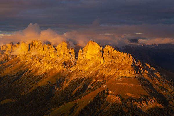 West wall of Roda de Vael and Catinaccio group at sunset from Latemar summit. Costalunga pass, Carezza, Trento district, Dolomites, Trentino Alto Adige, Italy, Europe.