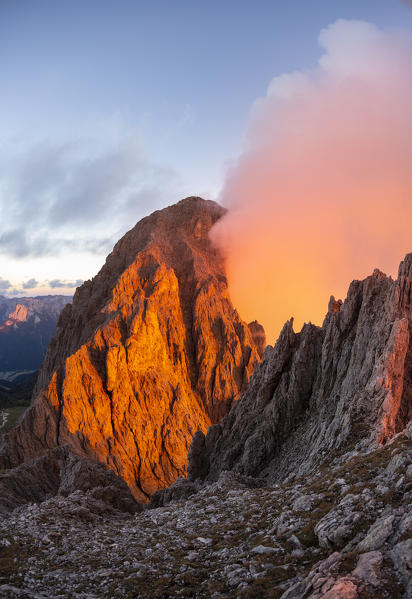 Cloudy sunset to Roda de Vael peak from the rocks of Vajolon pass. Roda de Vael refuge, Carezza pass, Fassa valley, Trento district, Dolomites, Trentino Alto Adige, Italy, Europe.