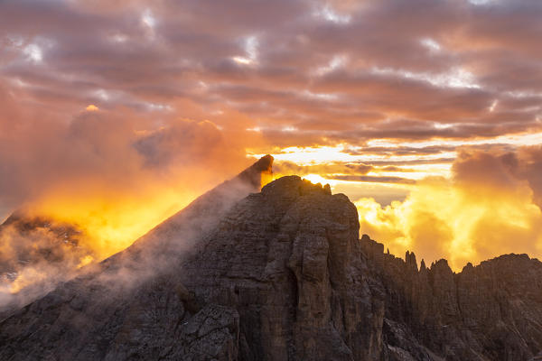 Latemar peak during a cloudy summer sunset from Schenon mount . Costalunga pass, Fiemme valley, Cavalese, Trento district, Dolomites, Italy, Europe. 
