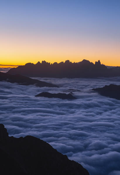 Sunrisescape of Dolomites mountains with Pale di San Martino group in background from Schenon mount. Costalunga pass, Fassa valley, Pozza di Fassa, Trento district, Dolomites, Italy, Europe.