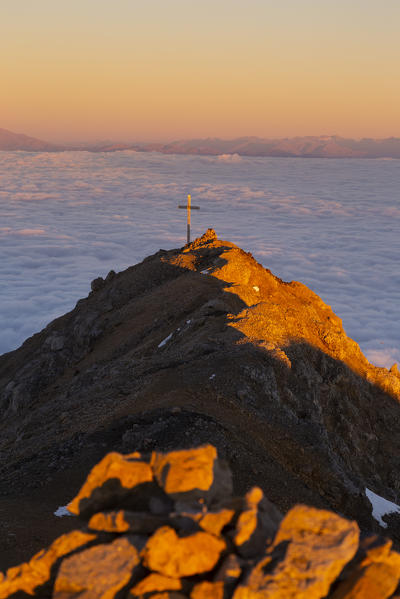 Sunrisescape in Dolomites mountains from Schenon mount over a cloudy carpet. Schenon mount, Latemar group, Costalunga pass, Fassa valley, Pozza di Fassa, Trento district, Dolomites, Italy, Europe.