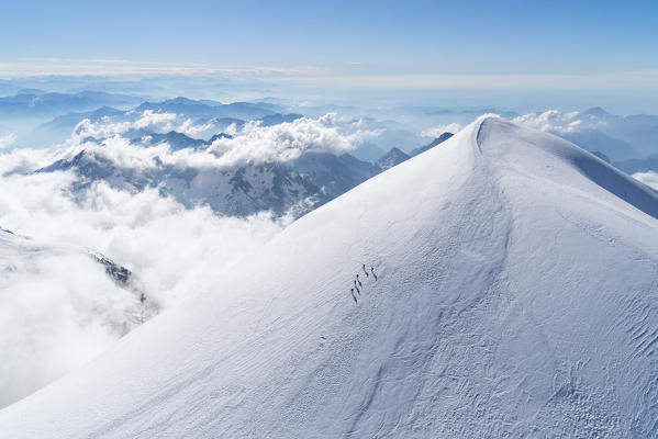 Alpinists descent Vincent Pyramid, one of the 4000 of Rosa group in the Alps. Gressoney, Aosta district, Valle d'Aosta, Alps, Italy, Europe. 