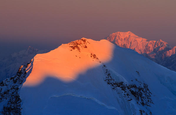 Lyskamm mount from Capanna Regina Margherita in Rosa mount at sunrise with Mount Blanc in the background. Gressoney, Aosta district, Valle d'Aosta, Alps, Italy, Europe.