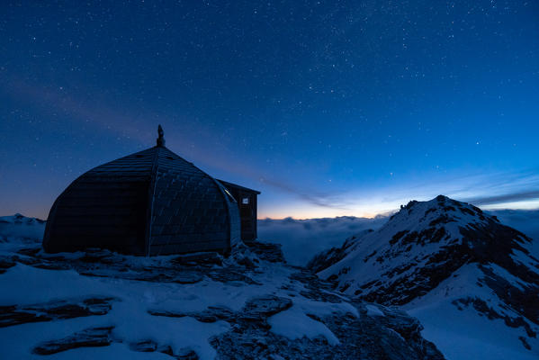 Nightscape of Igloo refuge des Pantalons Blancs in Swiss Alps mountains. Heremence, Sion, Valais canton, Switzerland, Europe.